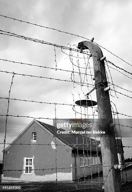 Barbwire fence and old barracks at the German concentration camp Buchenwald