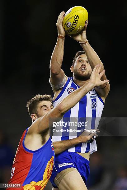 Aaron Black of the Kangaroos marks the ball against Jordan Lisle of the Lions during the round nine AFL match between the North Melbourne Kangaroos...