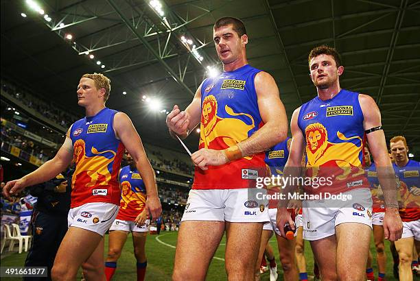 Mitch Golby Jonathan Brown and Pearce Hanley of the Lions walk off after their defeat during the round nine AFL match between the North Melbourne...