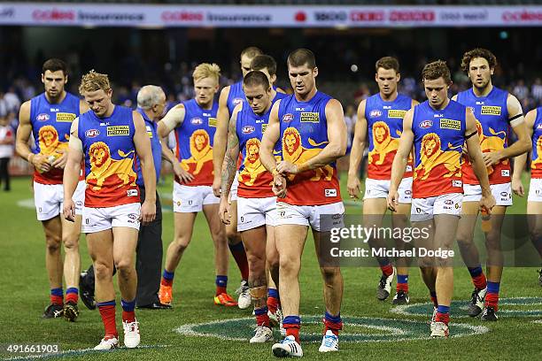 Jonathan Brown of the Lions and teamates walk off after their defeat during the round nine AFL match between the North Melbourne Kangaroos and the...