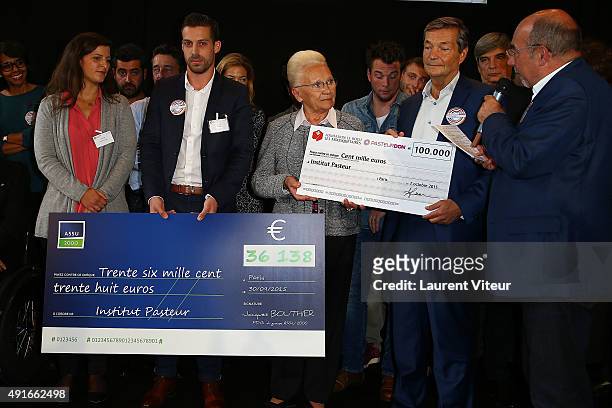 Assu2000 Marketing Director Nicolas Sailly and President of Foudation Le Roch les Mousquetaires Marie-Thrse Le Roch give a check of donation at...