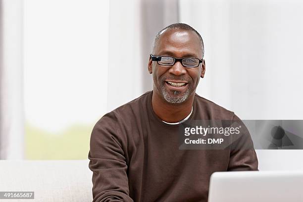 happy middle aged male using latest technology - 50 54 years stock pictures, royalty-free photos & images