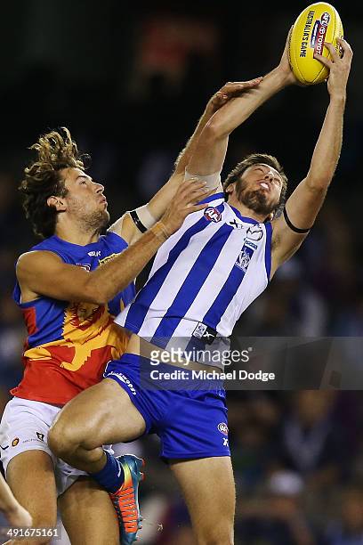 Sam Wright of the Kangaroos marks the ball against Marco Paparone of the Lions during the round nine AFL match between the North Melbourne Kangaroos...