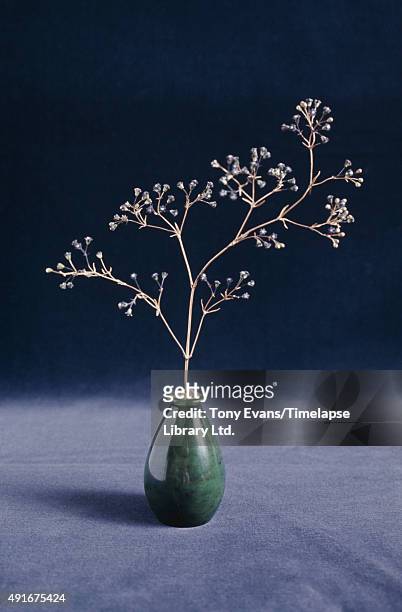 Fabergé sprig of flowers in a small vase, circa 1980.