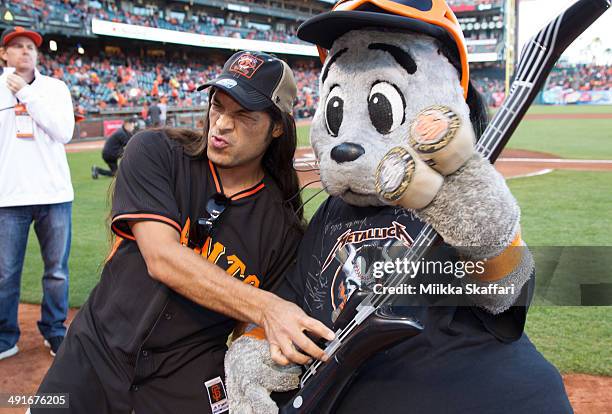 Bassist Robert Trujillo of Metallica and San Francisco Giants mascot Lou Seal bond before the National Anthem at AT&T Park on May 16, 2014 in San...
