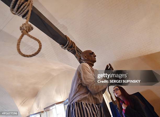 Visitor views an installation at the exhibition "Torture and Execution in the Middle Ages" during its opening in Kiev on October 7, 2015. AFP PHOTO/...