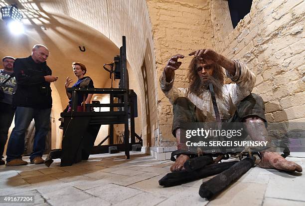 Visitors view an installation at the exhibition "Torture and Execution in the Middle Ages" during its opening in Kiev on October 7, 2015. AFP PHOTO/...