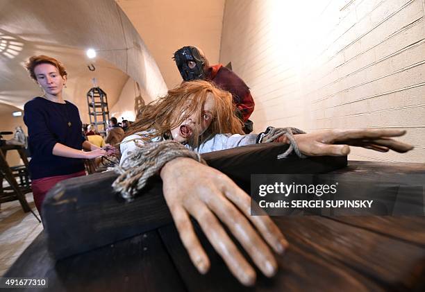 Visitor views an installation at the exhibition "Torture and Execution in the Middle Ages" during its opening in Kiev on October 7, 2015. AFP PHOTO/...