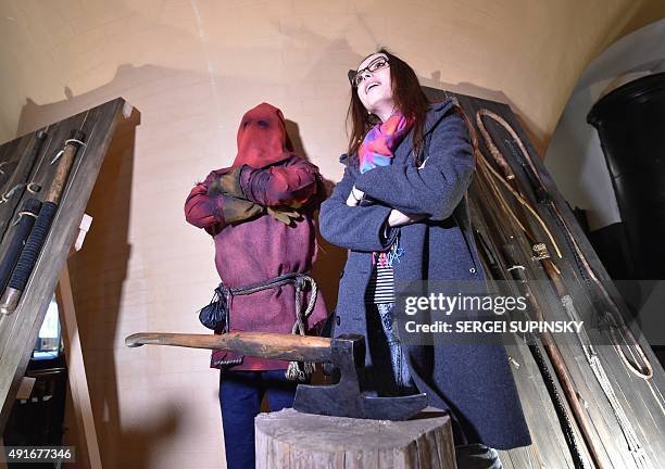 Visitor stands by an installation at the exhibition "Torture and Execution in the Middle Ages" during its opening in Kiev on October 7, 2015. AFP...