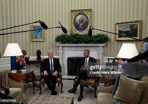 President Barack Obama and German President Joachim Gauck speak to the media during a meeting in the Oval Office at the White House October 7, 2015...