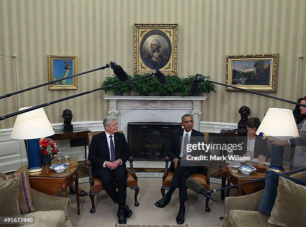 President Barack Obama and German President Joachim Gauck speak to the media during a meeting in the Oval Office at the White House October 7, 2015...