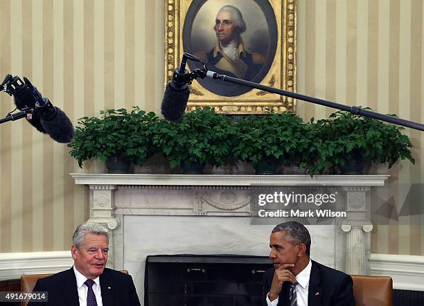President Barack Obama listens to German President Joachim Gauck speak during a meeting in the Oval Office at the White House October 7, 2015 in...