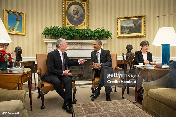 In this handout photo provided by the German Government Press Office , US President Barack Obama listens to German President Joachim Gauck speak...