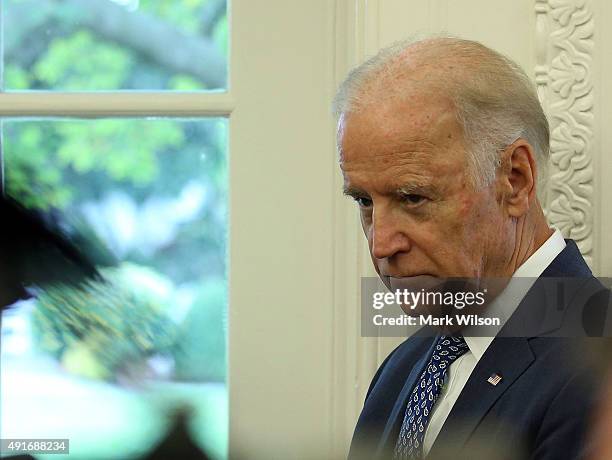 Vice President Joseph Biden listens to US President Barack Obama and German President Joachim Gauck speak during a meeting in the Oval Office at the...