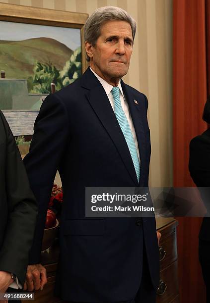 Secretary of State John Kerry attends a meeting with US President Barack Obama and German President Joachim Gauck in the Oval Office at the White...