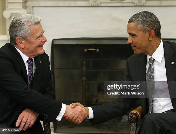 President Barack Obama shakes hands with German President Joachim Gauck during a meeting in the Oval Office at the White House October 7, 2015 in...