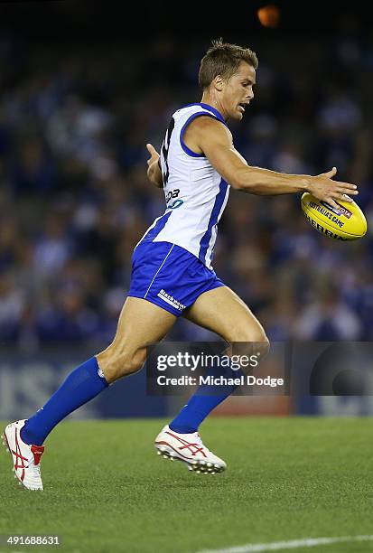 Andrew Swallow of the Kangaroos kicks the ball during the round nine AFL match between the North Melbourne Kangaroos and the Brisbane Lions at Etihad...