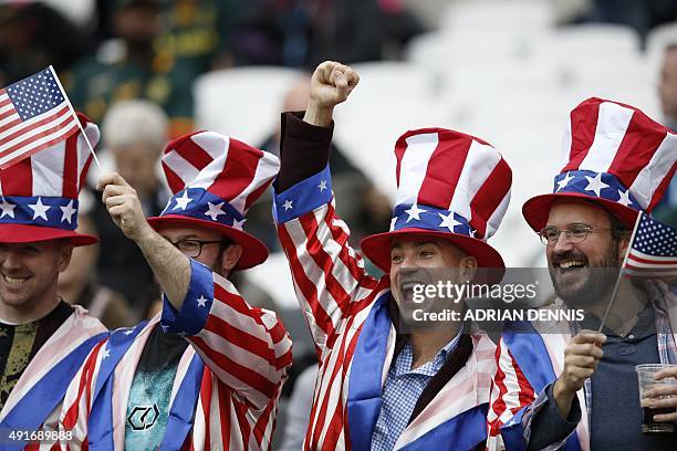 Supporters cheer during a Pool B match of the 2015 Rugby World Cup between South Africa and USA at the Olympic Stadium, east London, on October 7,...