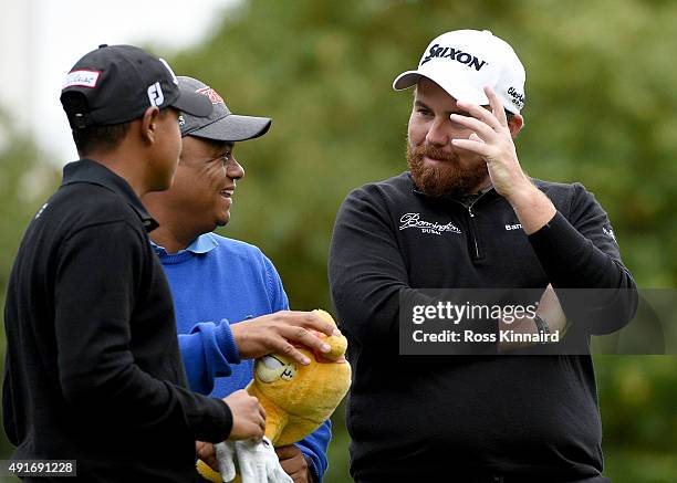 Junior golfer Robin Tiger Williams chatting to Shane Lowry of Ireland during the pro-am event prior to the British Masters at Woburn Golf Club on...