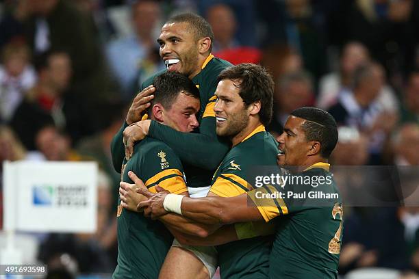 Jesse Kriel of South Africa is congratulated on his try by Bryan Habana of South Africa during the 2015 Rugby World Cup Pool B match between South...