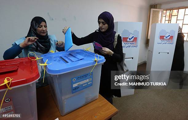 Libyan woman casts her ballot at a polling station during municipal elections in Tripoli, on May 17, 2014. Libyans go to the polls for the first...