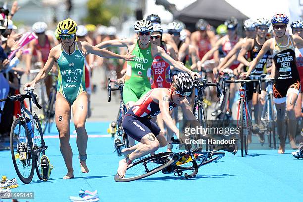 In this handout photo released by the International Triathlon Union, Great Britain's Jodie Stimpson falls entering transition at the 2014 ITU World...