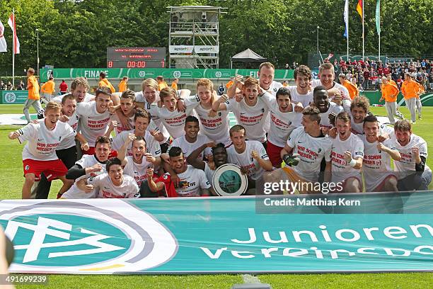 The team of Freiburg pose with the Cup after winning the DFB Juniors Cup final match between SC Freiburg and FC Schalke 04 at Stadion am Wurfplatz on...