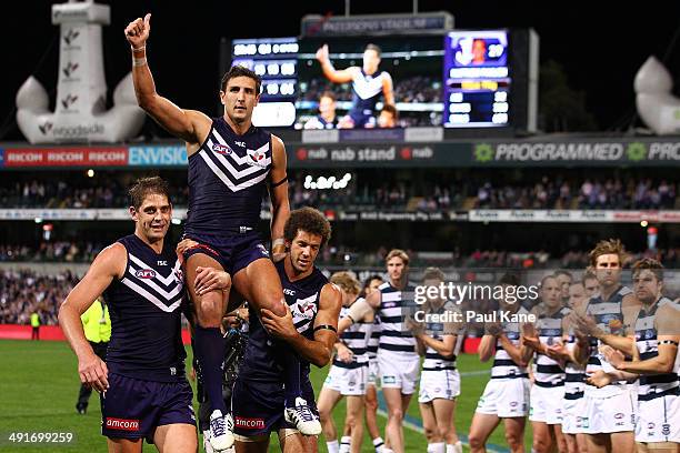 Matthew Pavlich of the Dockers is chaired from the ground by Aaron Sandilands and Zac Clarke after playing his 300th game and winning the round nine...