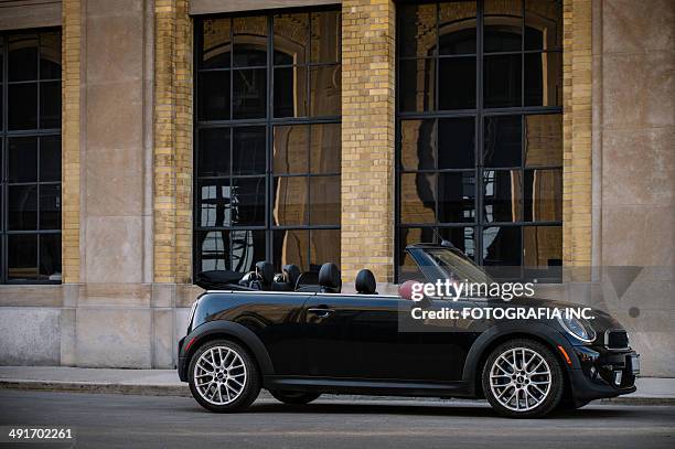 black mini convertible in spring time - mini vehicle brand name stock pictures, royalty-free photos & images
