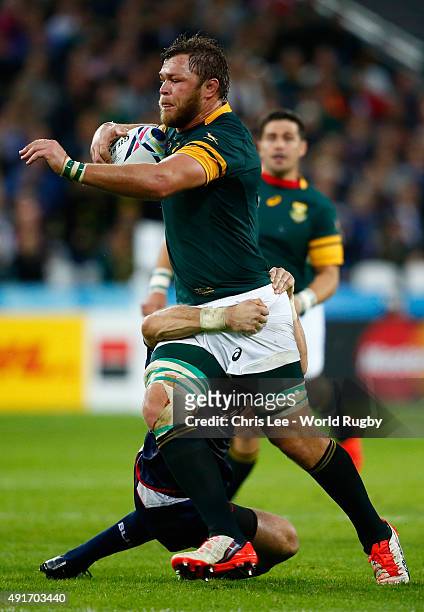 Duane Vermeulen of South Africa is tackled by Blaine Scully of the United States during the 2015 Rugby World Cup Pool B match between South Africa...
