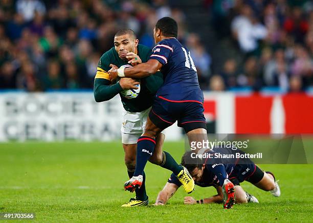 Bryan Habana of South Africa is tackled by Shalom Suniula of the United States during the 2015 Rugby World Cup Pool B match between South Africa and...