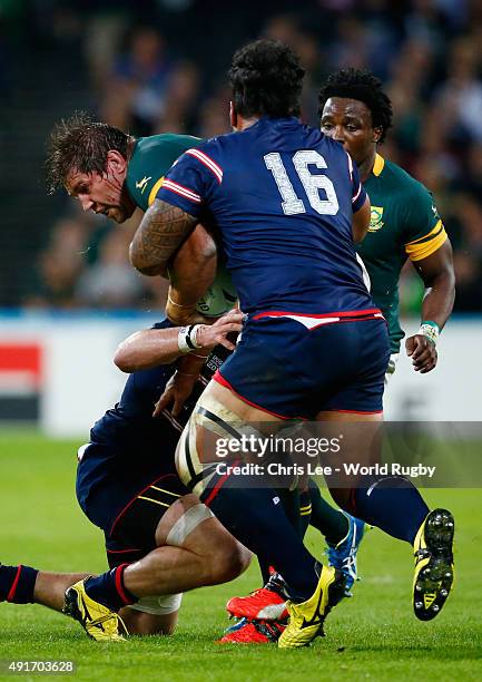 Willem Alberts of South Africa is tackled by Joe Taufetee of the United States during the 2015 Rugby World Cup Pool B match between South Africa and...