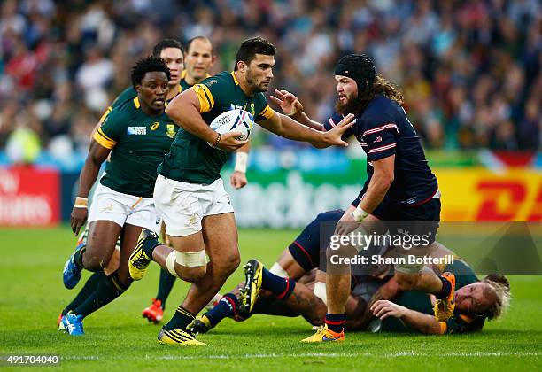 Damian De Allende of South Africa hands off Danny Barrett of the United States during the 2015 Rugby World Cup Pool B match between South Africa and...