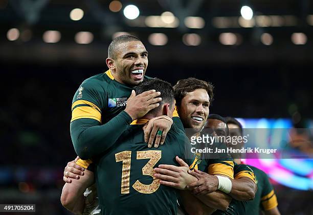 Jesse Kriel of South Africa celebrates his try with team mates Bryan Habana and Jan Serfontein during the 2015 Rugby World Cup Pool B match between...