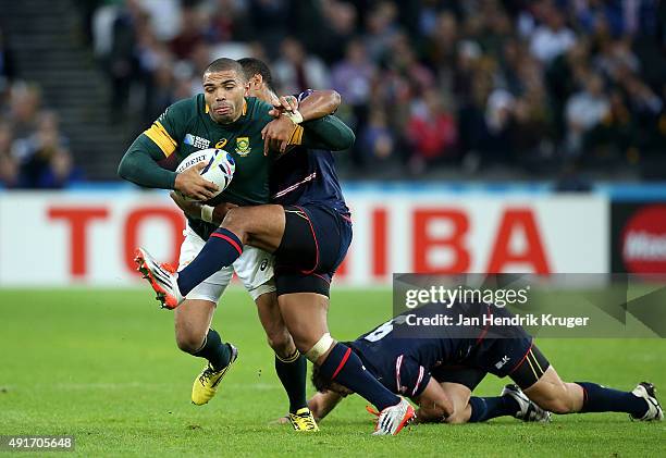 Bryan Habana of South Africa crashes through the tackles of Shalom Suniula and Niku Kruger of the United States during the 2015 Rugby World Cup Pool...