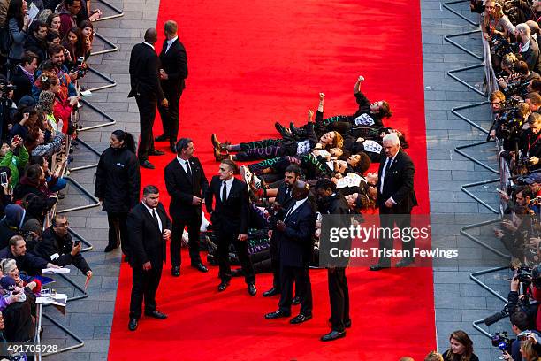 Feminist group Sisters Uncut protesting against cuts to support for victims of domestic violence occupy the red carpet during a protest at the...