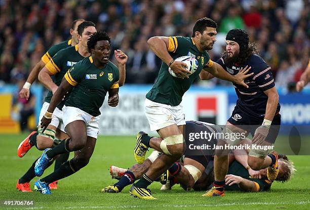 Damien de Allende of South Africa holds off Danny Barrett of the United States during the 2015 Rugby World Cup Pool B match between South Africa and...