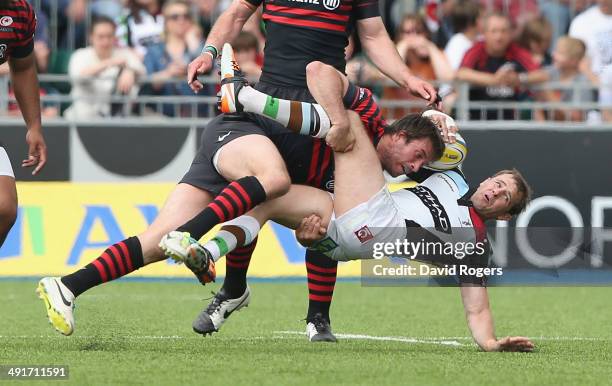 Marcelo Bosch of Saracens takes out Nick Evans which led to him being sin binned during the Aviva Premiership semi final match between Saracens and...