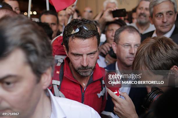 Former trader Jerome Kerviel is surrounded by journalists and supporters as he arrives near the French border on May 17, 2014 outside Vintimille ....