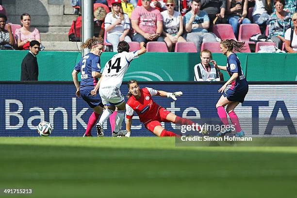 Kozue Ando of Frankfurt scores her team's first goal against Goalkeeper Lisa Weiss of Essen and Dominique Janssen of Essen during the Women's DFB Cup...