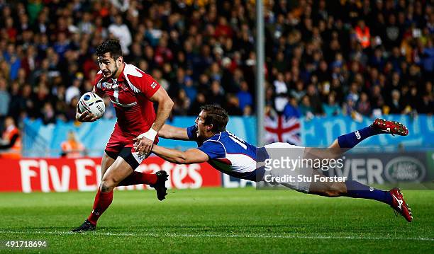 Lasha Malaguradze of Georgia breaks past Theuns Kotze of Namibia to score their second try during the 2015 Rugby World Cup Pool C match between...