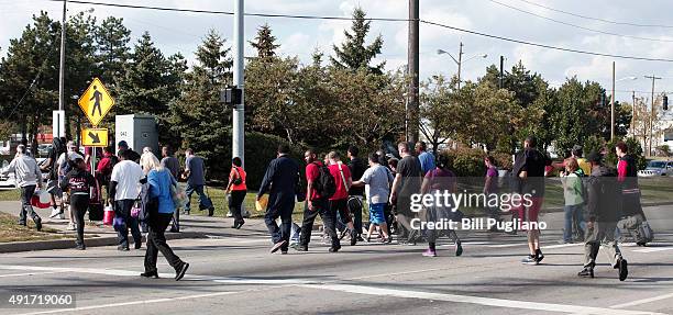 Fiat Chrysler Automobile workers exit from the Warren Truck Assembly Plant at the end of their shift October 7, 2015 in Warren, Michigan. The United...