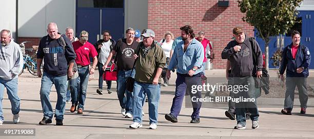 Fiat Chrysler Automobile workers exit from the Warren Truck Assembly Plant at the end of their shift October 7, 2015 in Warren, Michigan. The United...