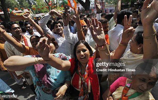 Supporters and workers celebrate during the BJP parliament board meeting, after party's landslide victory in Lok Sabha election, at BJP Headquarter...