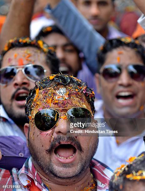 Supporters and workers celebrate during the BJP parliament board meeting, after party's landslide victory in Lok Sabha election, at BJP Headquarter...