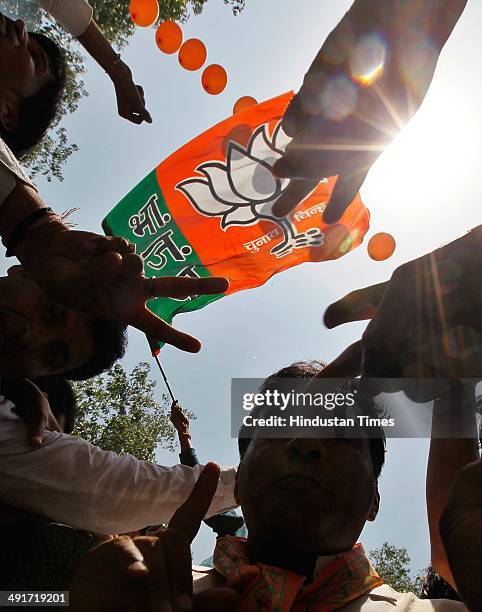 Supporters and workers celebrate during the BJP parliament board meeting, after party's landslide victory in Lok Sabha election, at BJP Headquarter...