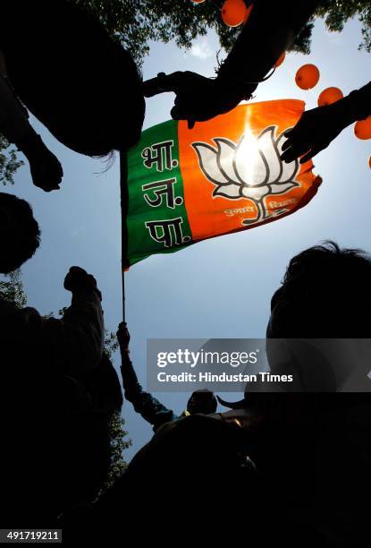 Supporters and workers celebrate during the BJP parliament board meeting, after party's landslide victory in Lok Sabha election, at BJP Headquarter...