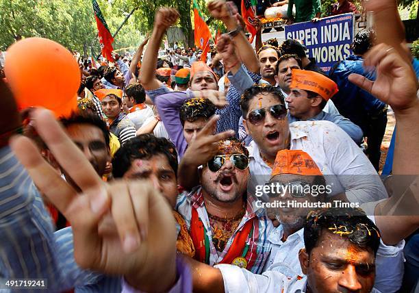 Supporters and workers celebrate during the BJP parliament board meeting, after party's landslide victory in Lok Sabha election, at BJP Headquarter...