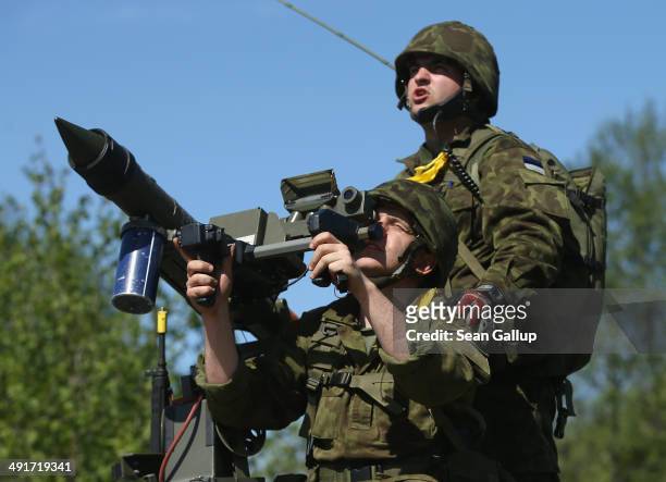 Members of an Estonian anti-aircraft unit aim a Mistral anti-aircraft missile at a fighter jet overhead while participating in the NATO "Spring...