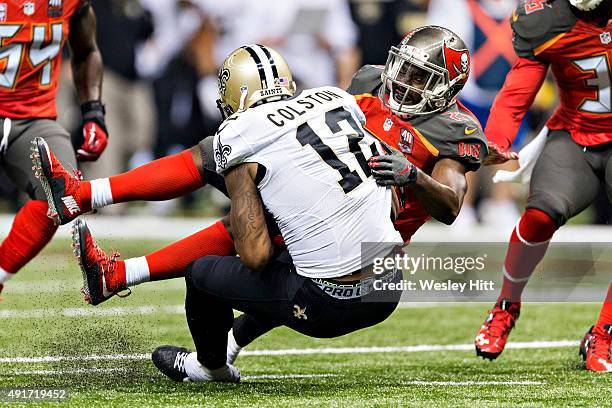 Marques Colston of the New Orleans Saints is tackled by Alterraun Verner of the Tampa Bay Buccaneers at Mercedes-Benz Superdome on September 20, 2015...